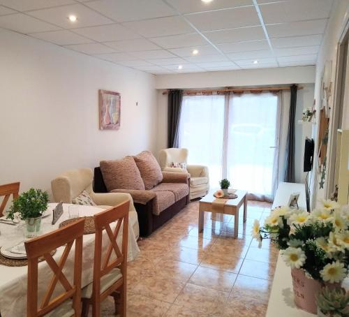 a living room with a couch and a table at Apartamento Sant Roc in Hospitalet de l'Infant