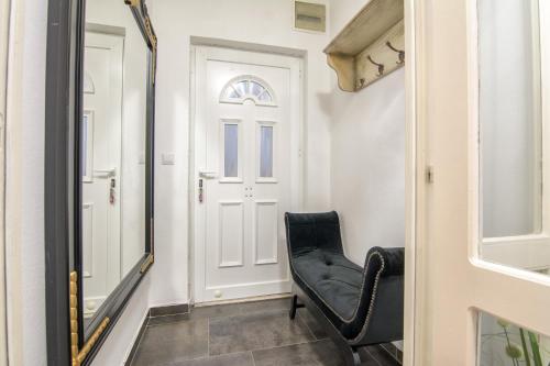 a black chair in a hallway with a door at Francesca Luxury Apartment in Zadar
