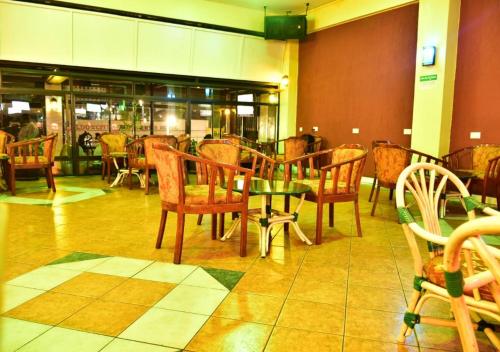 a dining room with chairs and a table in a restaurant at Klique Hotel Eldoret in Eldoret