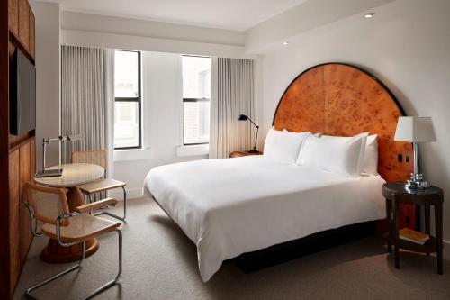 a hotel room with a large bed and a desk at Lyle DC in Washington, D.C.