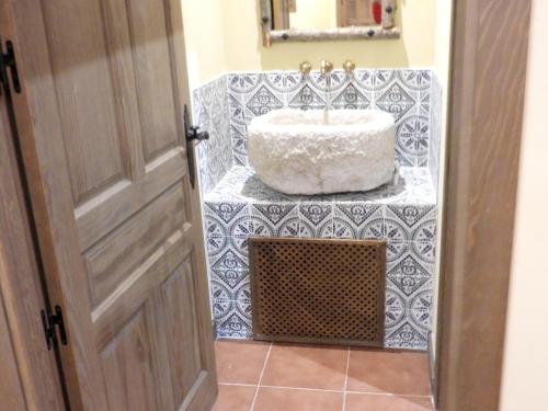 a bathroom with a sink on a tiled floor at Spacious Villa with Private Pool, Villafranca De Los Caballeros in Villafranca de los Caballeros