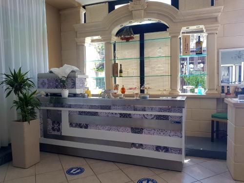 a kitchen with a sink and a window at Hotel Porto Badisco in Porto Badisco