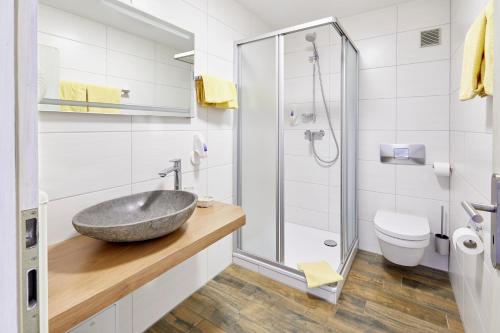 a bathroom with a sink and a shower at Landgasthof zur Sonne in Emmingen-Liptingen
