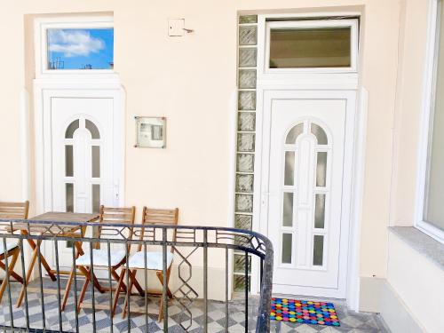 a patio with chairs and a table and a door at LUXURY apartment in the centre with a place for barbecue party in Budapest