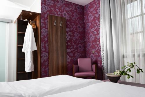 Ένα ή περισσότερα κρεβάτια σε δωμάτιο στο AKZENT Hotel Laupheimer Hof