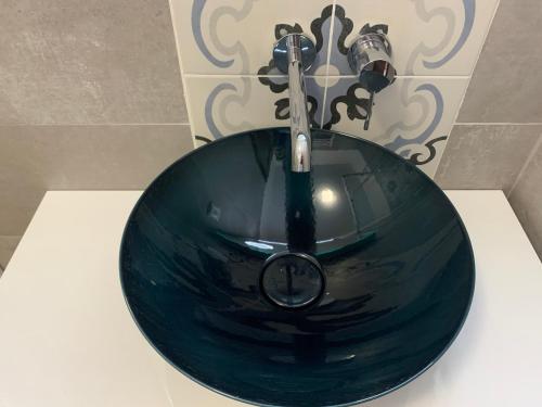 a sink in a bathroom with a green bowl at Quinta da Luz - A Luxury Boutique B&B in Silves
