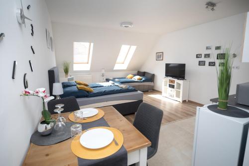 a living room with a couch and a table at Kossuth Apartmanház in Tata