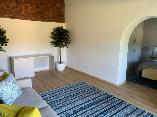 a living room with a couch and a table at Quinta da Luz - A Luxury Boutique B&B in Silves