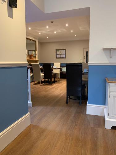 an empty waiting room with tables and chairs at Armada Guesthouse in Redcar