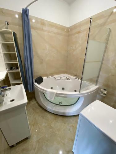 a bathroom with a bath tub and a sink at Welcome Apartments Center in Kyiv