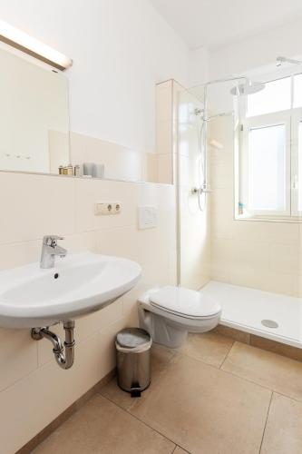a bathroom with a sink and a toilet and a shower at M9 Appartment in Garmisch-Partenkirchen
