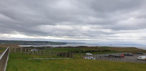 a view of a parking lot with a view of a lake at Causeway Hotel in Bushmills