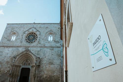 a sign on a wall in front of a church at Dimora Pardo in Larino