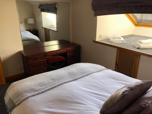 a bedroom with a bed and a dresser and a mirror at Beacon View in Penrith