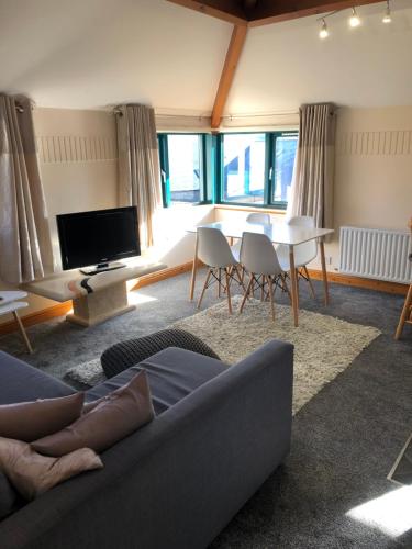 a living room with a couch and a table at Beacon View in Penrith