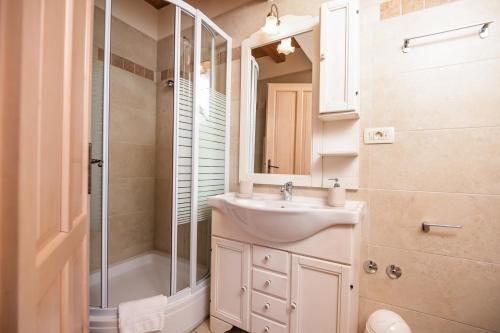 a bathroom with a sink and a shower at Villa Plasa Krk in Kras