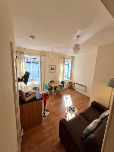 a living room with a couch and a table at Hebridean Town House in Stornoway