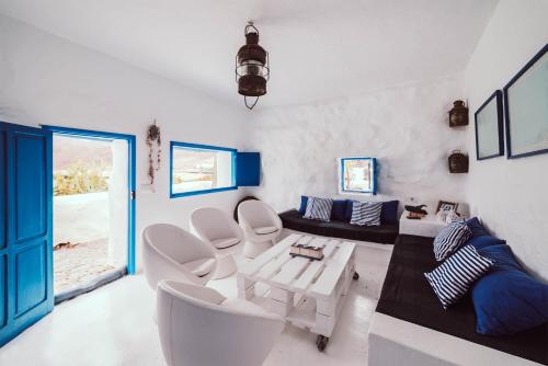 a living room with white chairs and a table at Seaside Villa La Graciosa in Pedro Barba
