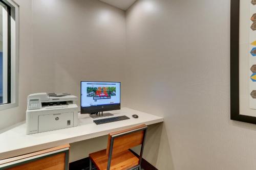 a computer sitting on a desk with a printer at Holiday Inn Express & Suites - Saugerties - Hudson Valley by IHG in Saugerties