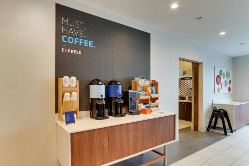 a coffee shop with a sign that says must have coffee at Holiday Inn Express & Suites - Saugerties - Hudson Valley by IHG in Saugerties