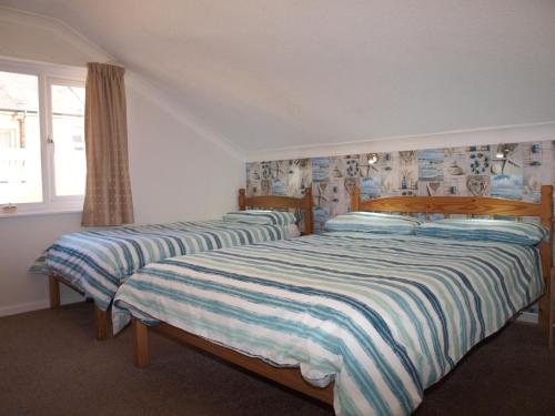A bed or beds in a room at Blantyre Guest House 