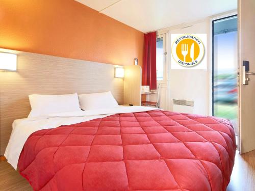 a large red bed in a hotel room at Premiere Classe Lille Sud - Seclin in Seclin