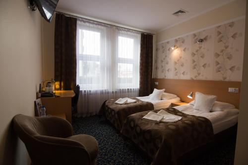 Postel nebo postele na pokoji v ubytování Hotel Trojka