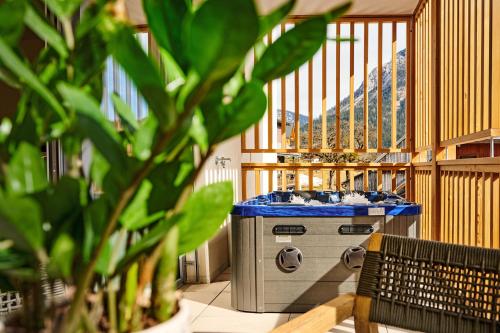 a kitchen with a stove in a room at die Tauplitz Lodges - Alm Lodge A3 by AA Holiday Homes in Tauplitz