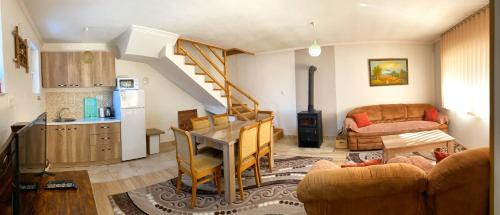 a living room with a table and a kitchen at Chalet Kujta in Peje