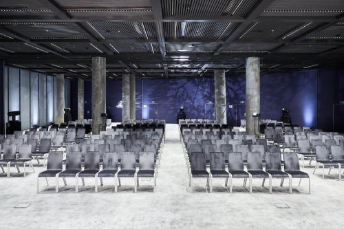 an empty room with chairs and a stage at Crowne Plaza - Warsaw - The HUB by IHG in Warsaw