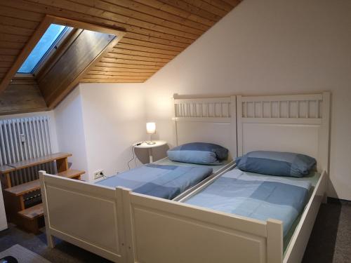 a bedroom with two beds and a skylight at Ferienwohnung- Alpengaudi in Missen-Wilhams