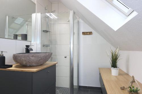 a bathroom with a sink and a glass shower at Haus Ostseenordstern Rerik in Rerik