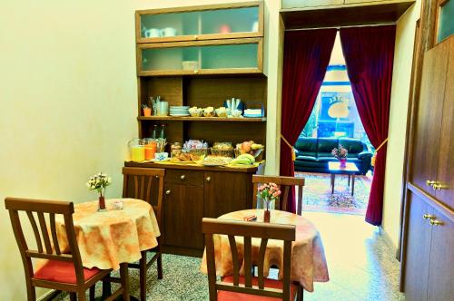 a dining room with two tables and a counter at Hotel Pavone in Milan