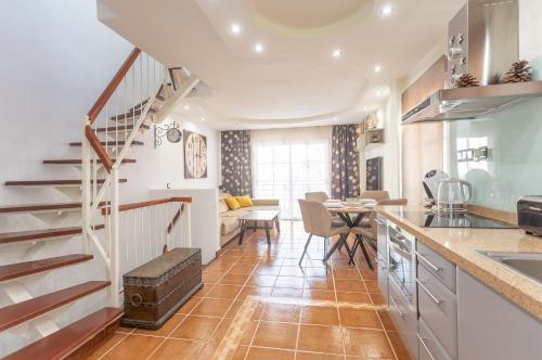 a kitchen with a staircase and a dining room at Aqua Vista 2 bed Penthouse with great views in Callao Salvaje