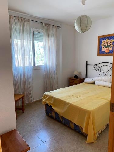 a bedroom with a large bed and a window at El Castell Orange Costa in Alcossebre