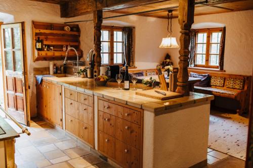 a kitchen with wooden cabinets and a counter top at Steinbachhof Chiemsee in Bernau am Chiemsee