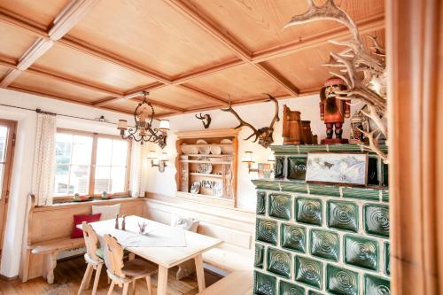 a dining room with a table and chairs at Gästehaus Hotel Maria Theresia in Schliersee