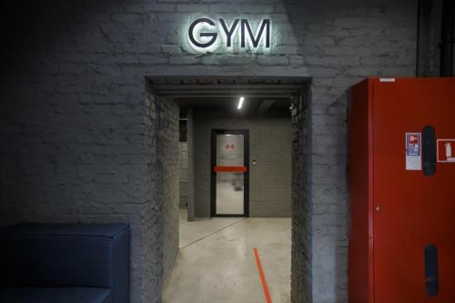 a room with a gm sign on a brick wall at Campus Community A-Hotel in Kyiv