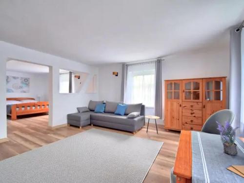 a living room with a couch and a bedroom at Nemo Mielenko in Mielenko