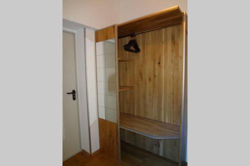 a room with a closet with a wooden door at Charmante rustikale Jägersuite mit el Kamin H2O Therme Oberhof in Oberhof