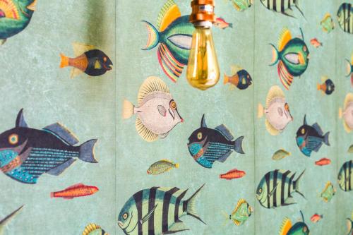 a towel with fish on it with a light at Il Cefalo Hotel & Restaurant in Castellabate