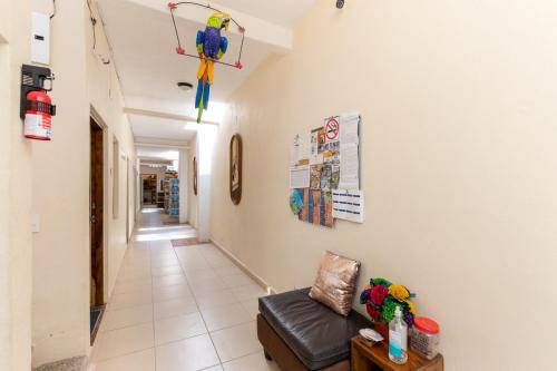 a hallway with a couch and a kite on the wall at Suites de Mita - Boutique Hotel in Punta Mita