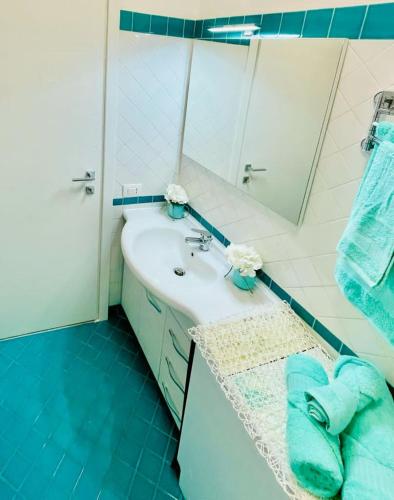a bathroom with a sink and a mirror at La Risacca Suite in Patti