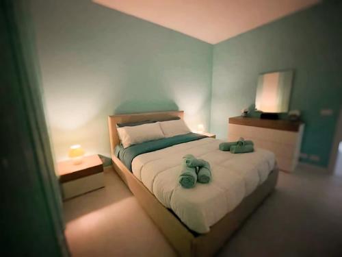 a bedroom with a bed with two stuffed animals on it at La Risacca Suite in Patti