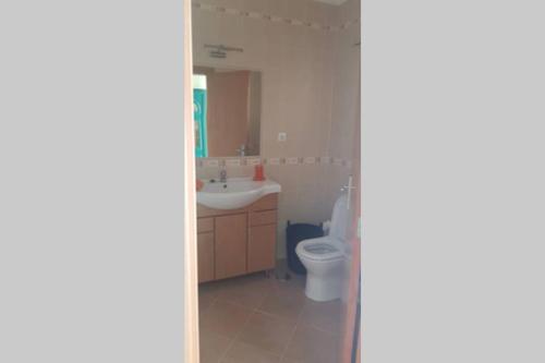 a bathroom with a toilet and a sink at Moradia em Altura! Beach House in Altura