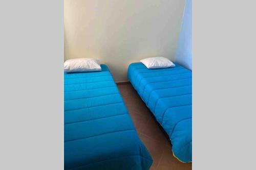 Un pat sau paturi într-o cameră la Moradia em Altura! Beach House