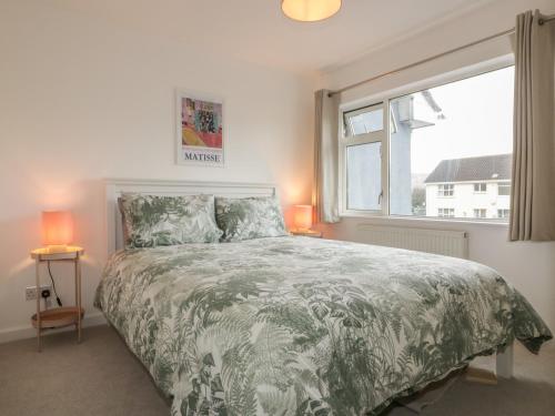 a bedroom with a large bed and a window at Eloen in Newquay