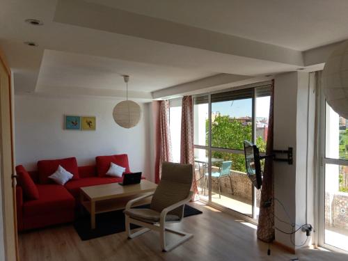 a living room with a red couch and a table at Taza Organic Garden with view park and restaurant in Taza