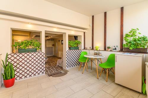 a patio with a table and chairs and plants at Geppetto’s Studio Brasov in Braşov