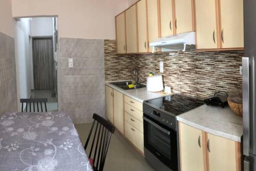 a kitchen with a table and a stove top oven at Loutraki Vibes Apartments in Loutraki
